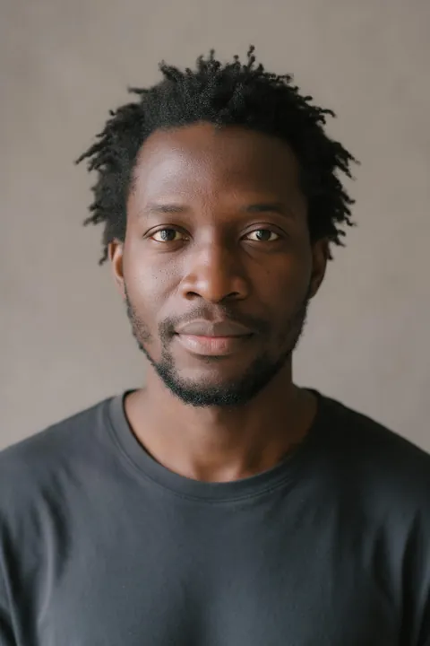 Jordan's photo: short natural hair grown out unevenly and a patchy beard.