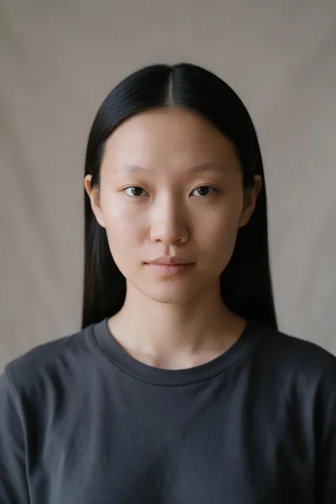 Mei's photo: long straight black hair worn flat with a blunt center part.