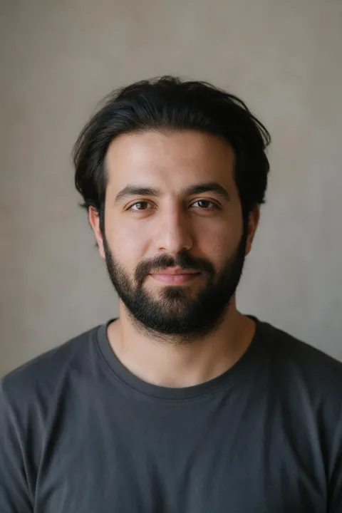 Omar's photo: thick hair grown out flat on top and an untrimmed beard.
